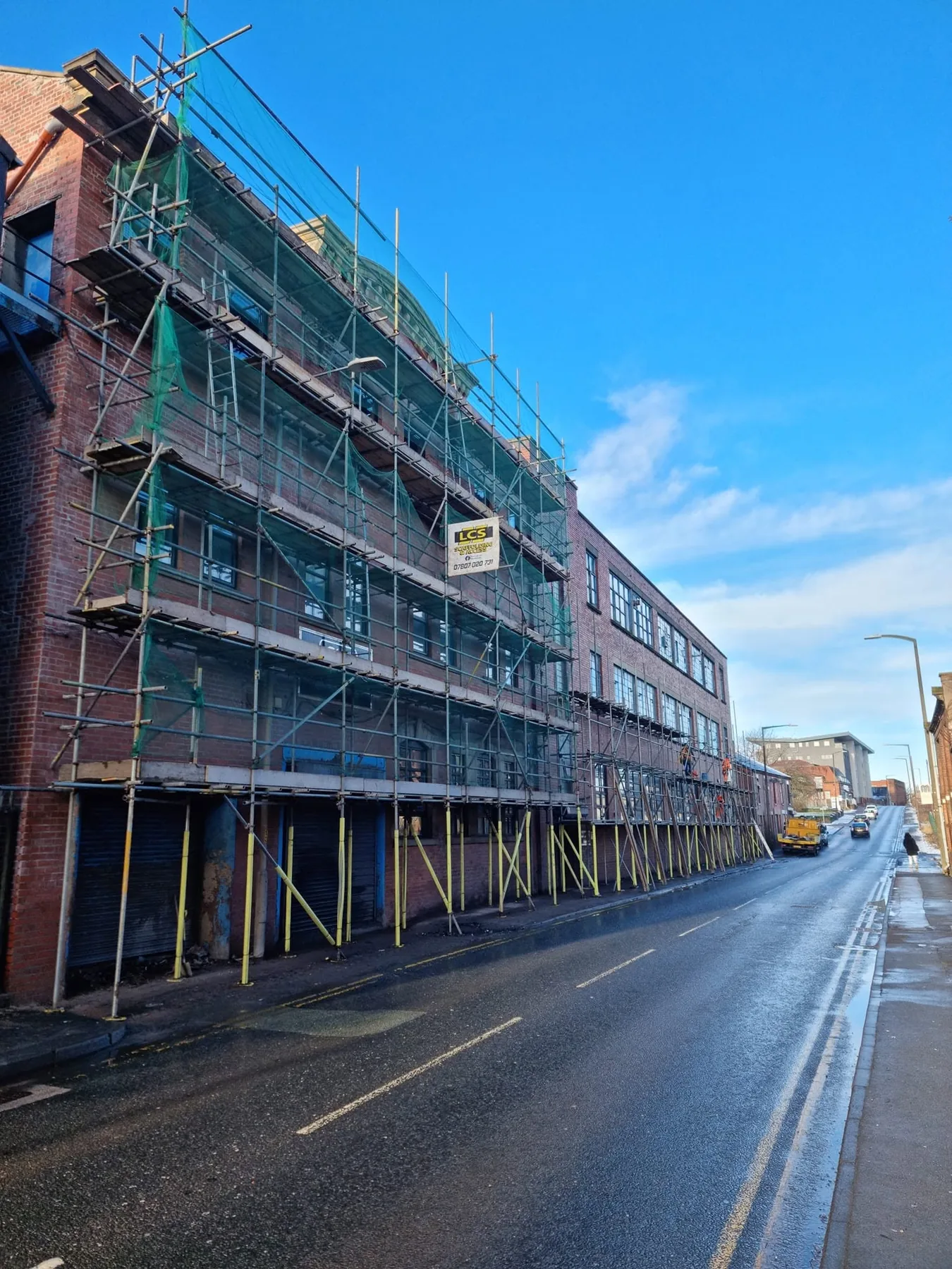 Commercial scaffold erected along a street frontage with LCS site signage