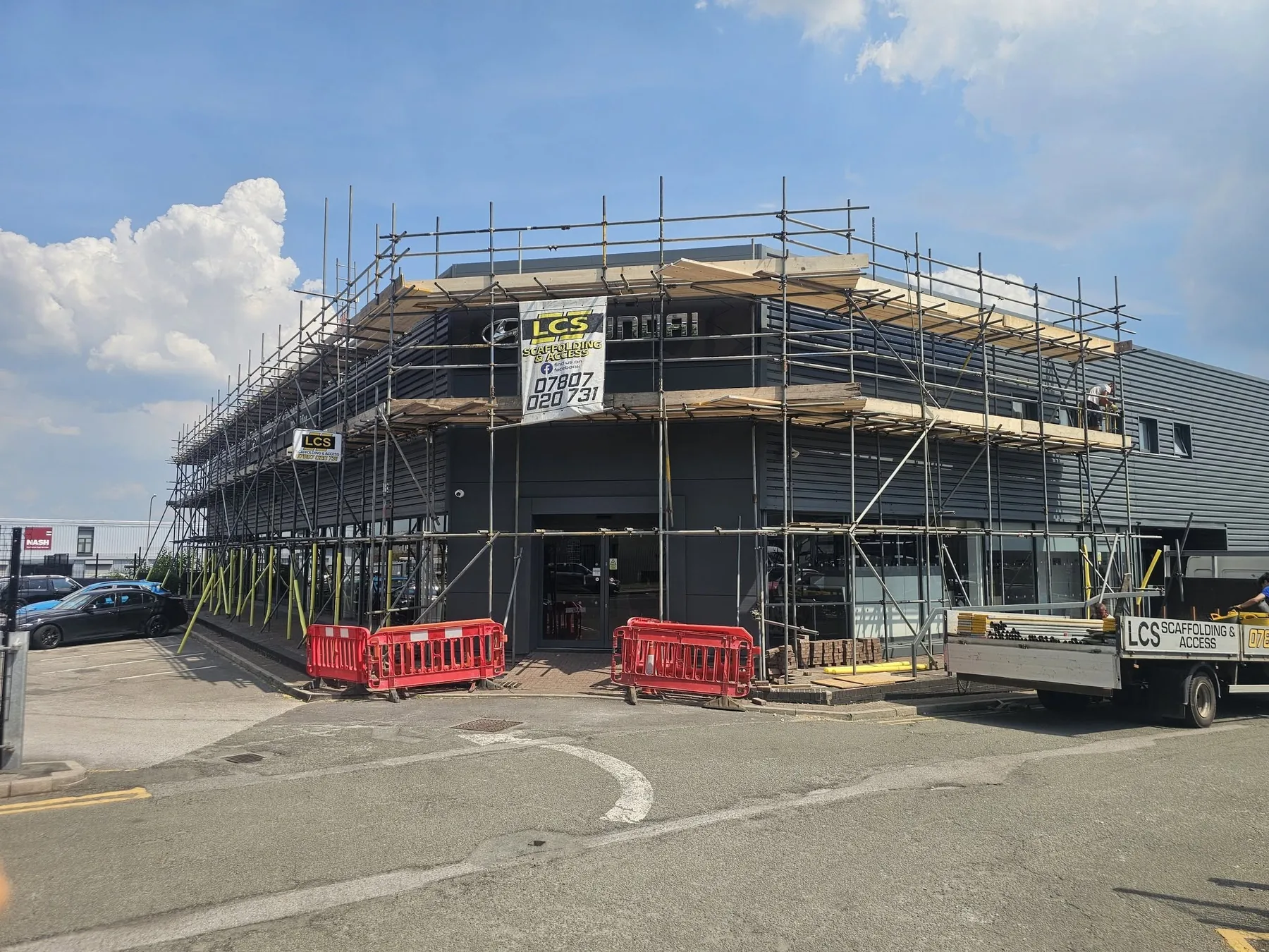 Commercial corner scaffold with LCS signage and road frontage