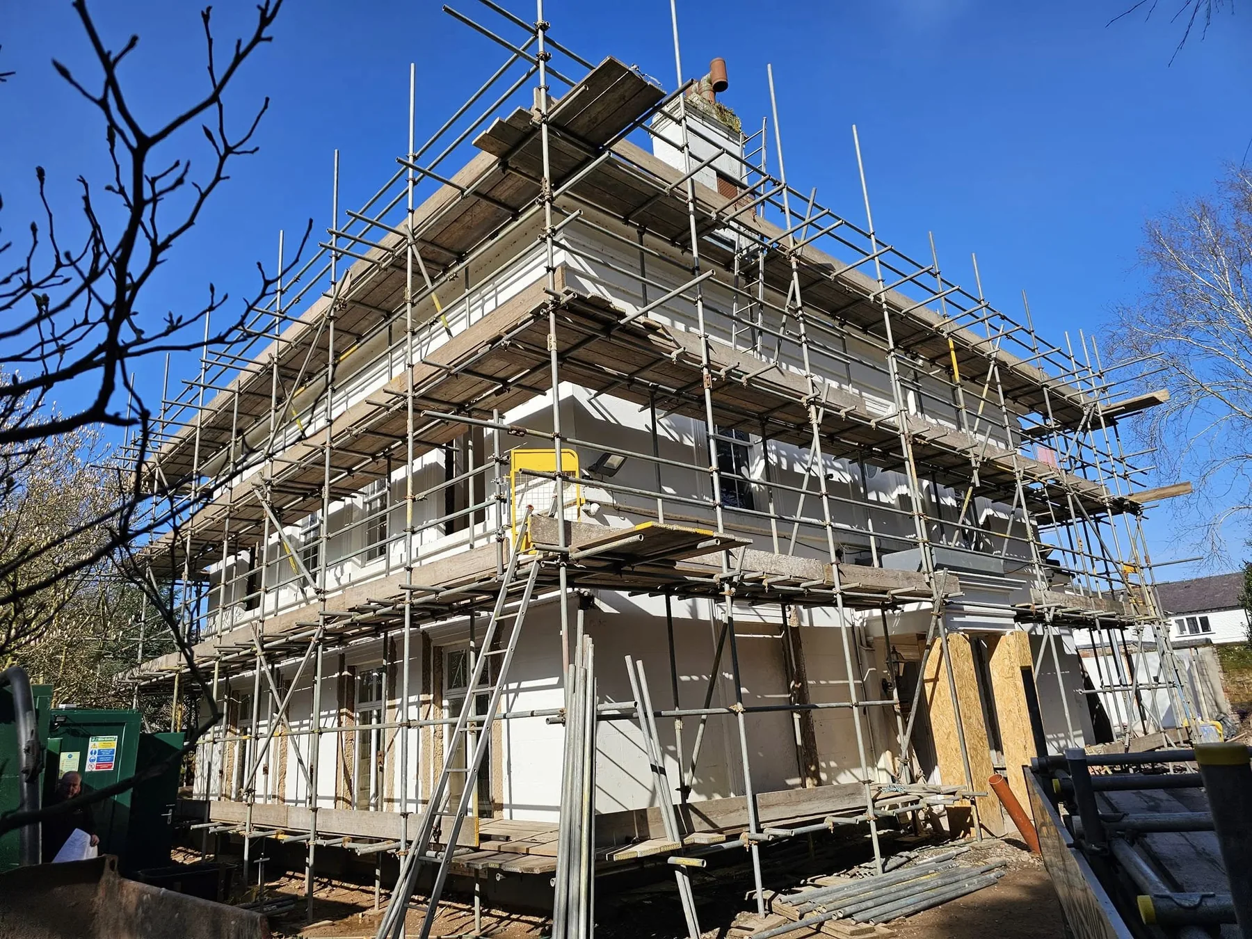 Full-wrap residential scaffold around a house renovation